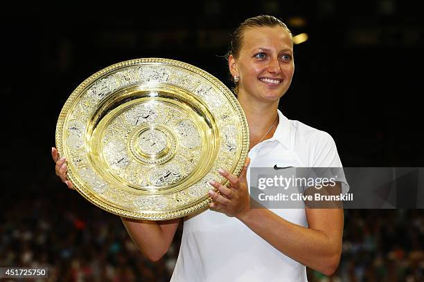 Petra Kvitova of Czech Republic poses with the Venus Rosewater Dish trophy after her victory in the Ladies' Singles final match against Eugenie...