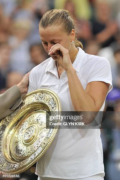 Czech Republic's Petra Kvitova cries as she holds the winner's Venus Rosewater Dish during the trophy presentation after beating Canada's Eugenie...