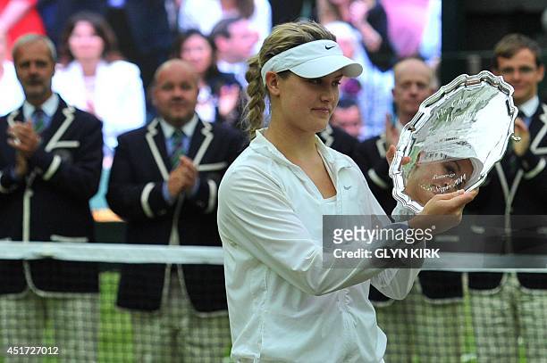 Runner up Canada's Eugenie Bouchard holds her trophy after losing to Czech Republic's Petra Kvitova the women's singles final match on day twelve of...