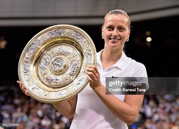Petra Kvitova poses with the Venus Rosewater Dish after beating Eugenie Bouchard in the ladies singles final on centre court during day twelve of the...