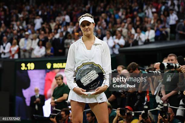 Eugenie Bouchard of Canada poses with the runner-up trophy after the Ladies' Singles final match against Petra Kvitova of Czech Republic on day...