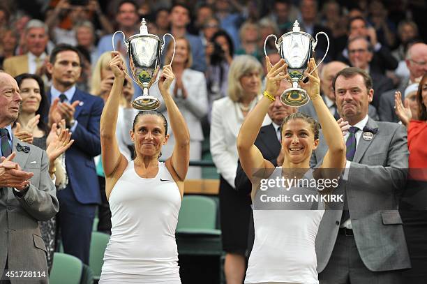 Italy's Sara Errani and Roberta Vinci hold their winners' trophies during the presentation after winning their women's doubles final match against...