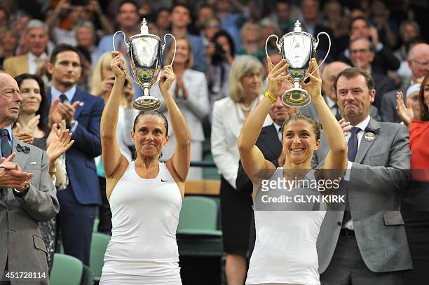 Italy's Sara Errani and Roberta Vinci hold their winners' trophies during the presentation after winning their women's doubles final match against...