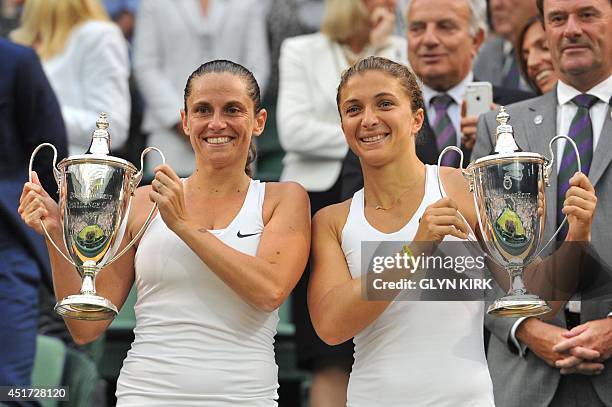 Italy's Sara Errani and Roberta Vinci hold their winners' trophies during the presentation after winning their women's doubles final match against...