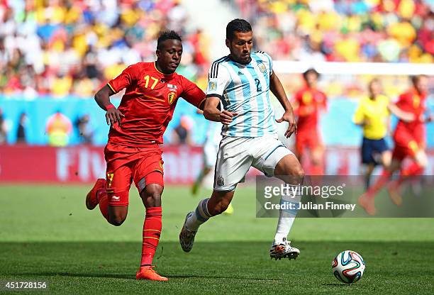 Divock Origi of Belgium challenges Ezequiel Garay of Argentina during the 2014 FIFA World Cup Brazil Quarter Final match between Argentina and...