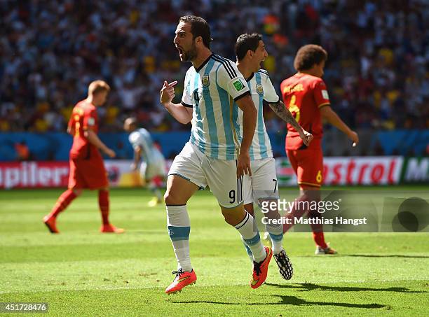 Gonzalo Higuain of Argentina celebrates scoring his team's first goal with Angel di Maria during the 2014 FIFA World Cup Brazil Quarter Final match...