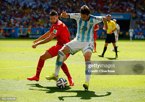 Kevin Mirallas of Belgium and Jose Maria Basanta of Argentina compete for the ball during the 2014 FIFA World Cup Brazil Quarter Final match between...