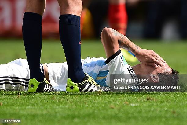 Argentina's midfielder Angel Di Maria reacts after a fall during a quarter-final football match between Argentina and Belgium at the Mane Garrincha...