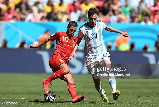 Eden Hazard of Belgium vies with Jose Maria Basanta of Argentina during the 2014 FIFA World Cup Brazil Quarter Final match between Argentina and...