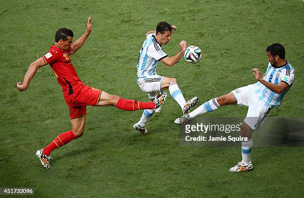 Daniel Van Buyten of Belgium competes for the ball with Martin Demichelis and Ezequiel Garay of Argentina during the 2014 FIFA World Cup Brazil...