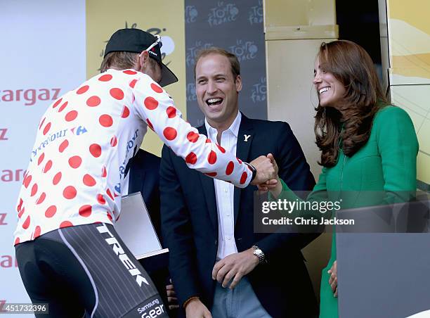 Prince William, Duke of Cambridge and Catherine, Duchess of Cambridge greet Jens Voigt of Germany and Trek Factory Racing on the podium at the finish...