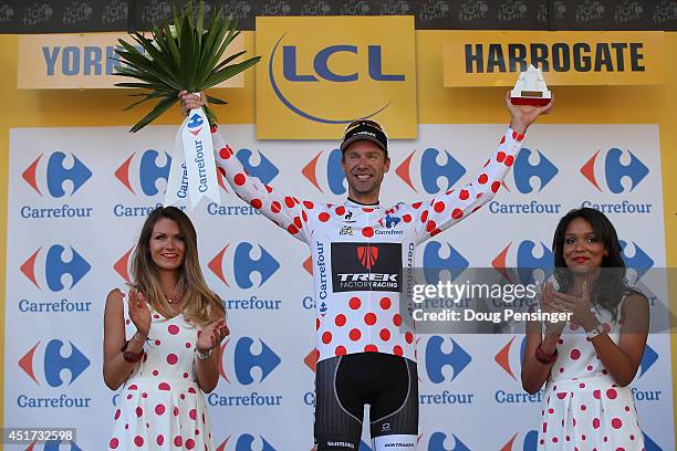 Jens Voigt of Germany and Trek Factory Racing takes the podium after winning the king of the mountains polka dot jersey in stage one of the 2014 Tour...