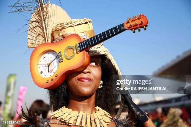 Woman poses as she arrives dressed up for a fashion competition during the annual Durban July horse race on July 5 in Durban, South Africa. The...