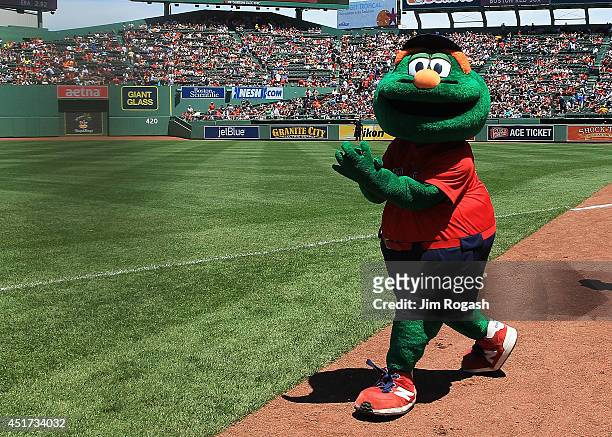 Wally the Green Monster participates in pre-game activities before the first game of a doubleheader between the Baltimore Orioles and the Boston Red...