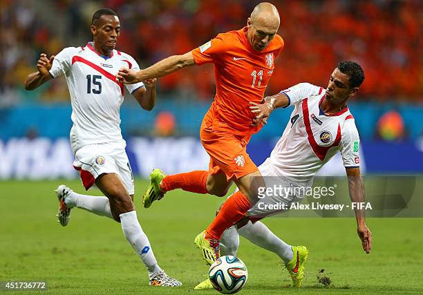 Arjen Robben of the Netherlands competes for the ball against Junior Diaz and Michael Umana of Costa Rica during the 2014 FIFA World Cup Brazil...