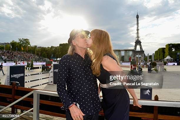 Elliott Murphy and his companion attend the Paris Eiffel Jumping presented by Gucci at Champ-de-Mars on July 5, 2014 in Paris, France.