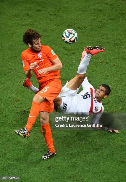 Cristian Gamboa of Costa Rica attempts a clearance against Daley Blind of the Netherlands during the 2014 FIFA World Cup Brazil Quarter Final match...