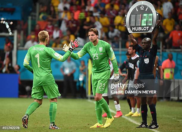 Netherlands' goalkeeper Jasper Cillessen shakes hands with Netherlands' goalkeeper Tim Krul as he leaves the field, during a quarter-final football...