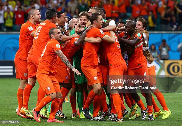 Goalkeeper Tim Krul of the Netherlands celebrates with teammates after making a save in a penalty shootout to defeat Costa Rica during the 2014 FIFA...