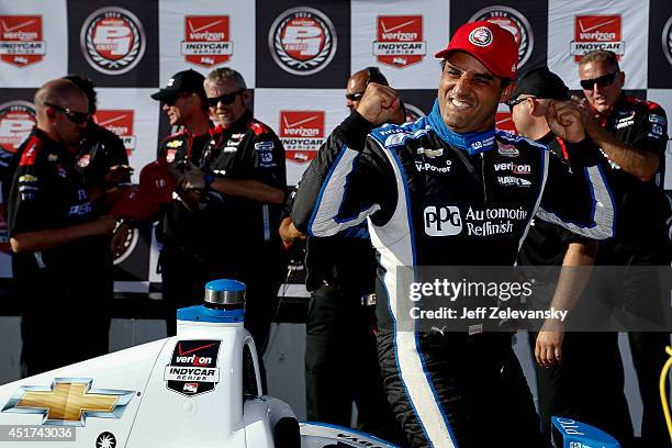 Juan Pablo Montoya of Colombia driver of the PPG Team Penske Chevrolet climbs out of his car after winning the pole during qualifying for the Pocono...