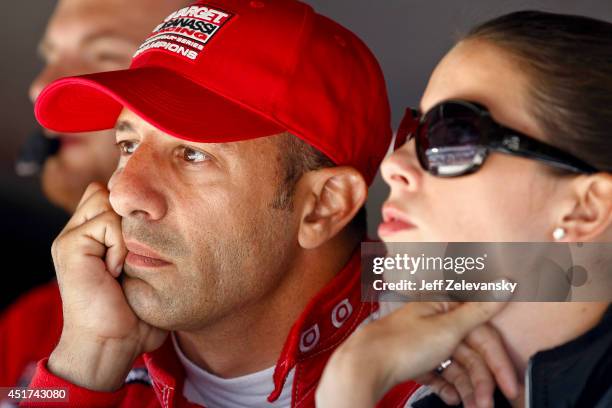 Tony Kanaan of Brazil driver of the Target Chip Ganassi Racing Chevrolet stands in the garage area during qualifying for the Pocono INDYCAR 500 at...