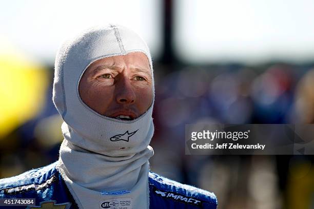 Ryan Briscoe of Australia driver of the NTT Data Chip Ganassi Racing Chevrolet stands on the grid during qualifying for the Pocono INDYCAR 500 at...