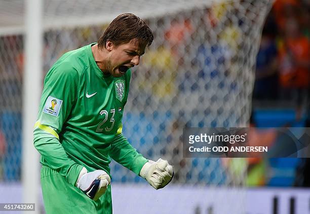 Netherlands' goalkeeper Tim Krul celebrates saving a penalty during the penalty shoot-out of the quarter-final football match between the Netherlands...