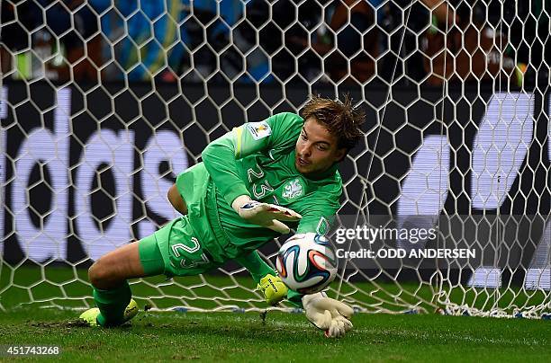 Netherlands' goalkeeper Tim Krul saves a penalty during the penalty shoot-out of the quarter-final football match between the Netherlands and Costa...