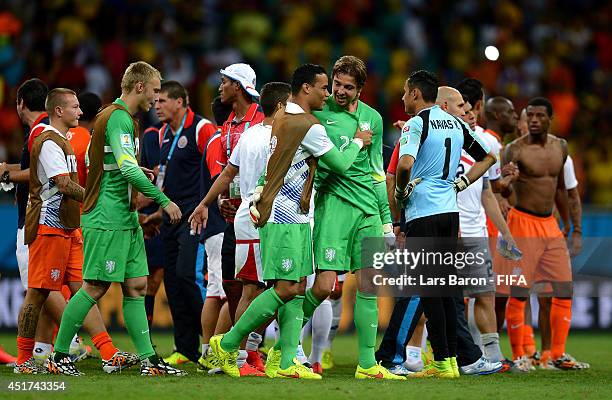 Tim Krul of the Netherlands is congratulated by Michel Vorm and Jasper Cillessen on the win in the penalty shootout after the 2014 FIFA World Cup...