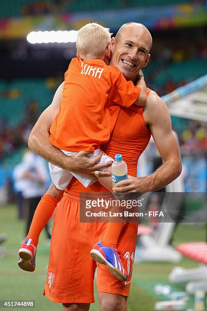 Arjen Robben of the Netherlands celebrates the win with his son Luka after the 2014 FIFA World Cup Brazil Quarter Final match between Netherlands and...