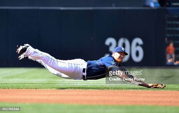 Brooks Conrad of the San Diego Padres makes a diving stop on a single hit by Hunter Pence of the San Francisco Giants during the first inning of a...
