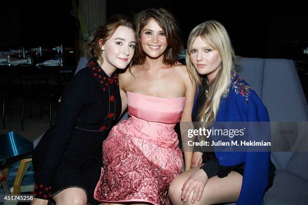 Saoirse Ronan, Gemma Arterton and Sophie Kennedy Clark attend Miu Miu Resort Collection 2015 at Palais d'Iena on July 5, 2014 in Paris, France.