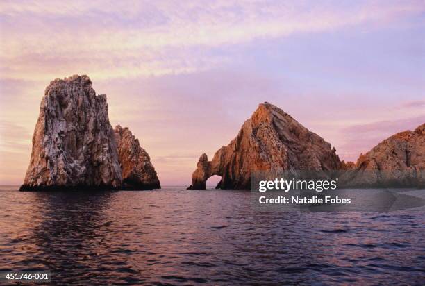 mexico,cabo san lucas, the arch rock formation in sea at dawn - natural arch stock pictures, royalty-free photos & images