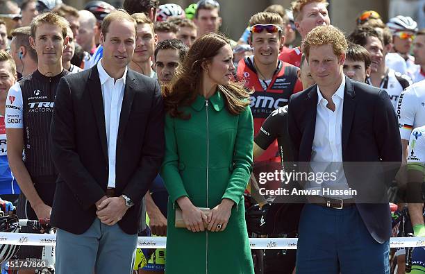 Catherine, Duchess of Cambridge, Prince William, Duke of Cambridge and Prince Harry pose with cyclists before cutting cut the ribbon at the official...