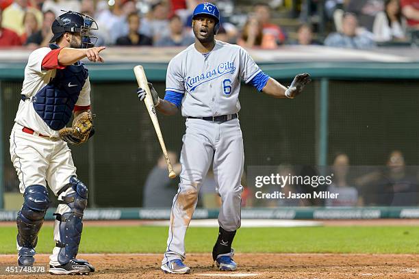 Catcher George Kottaras of the Cleveland Indians signals to first as Lorenzo Cain of the Kansas City Royals says he did not swing during the ninth...