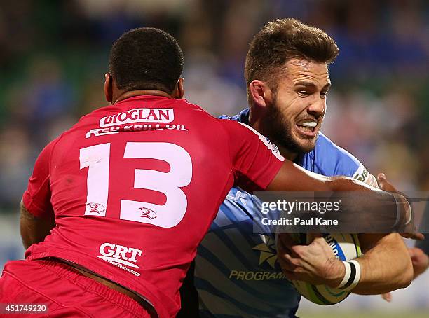 Zack Holmes of the Force gets tackled by Samu Kerevi of the Reds during the round 18 Super Rugby match between the Western Force and the Queensland...