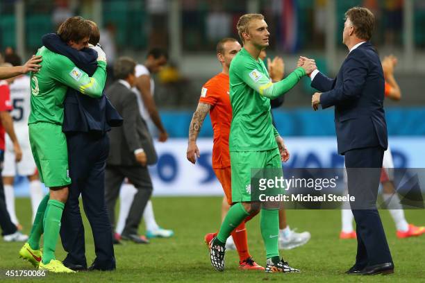Goalkeeper Jasper Cillessen of the Netherlands celebrates with head coach Louis van Gaal as substitute goalkeeper Tim Krul receives the plaudits...