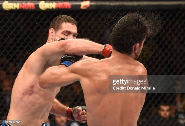 Middleweight champion Chris Weidman punches Lyoto Machida in their UFC middleweight championship fight at UFC 175 inside the Mandalay Bay Events...