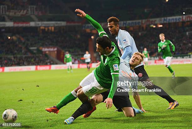 Mehmet Ekici of Bremen challenges for the ball with Johannes Geis of Mainz during the Bundesliga match between Werder Bremen and 1. FSV Mainz 05 at...