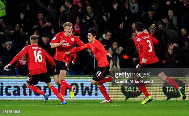 Kim Bo-Kyung of Cardiff celebrates with teammates after scoring an injury time goal to level the scores at 2-2 during the Barclays Premier League...