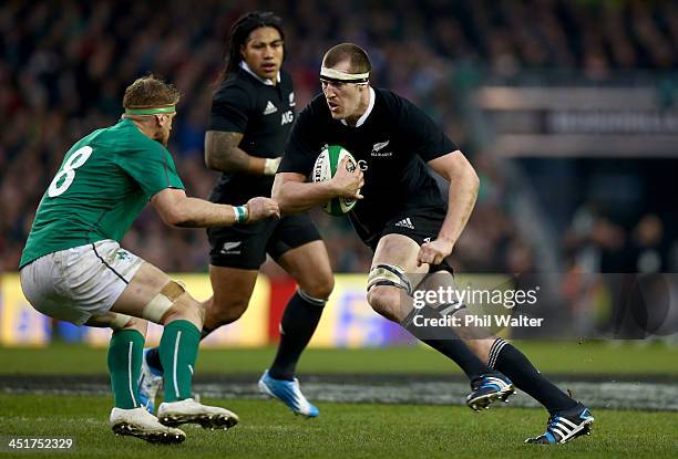 Brodie Retallick of the All Blacks charges at Jamie Heaslip of Ireland during the International match between Ireland and the New Zealand All Blacks...