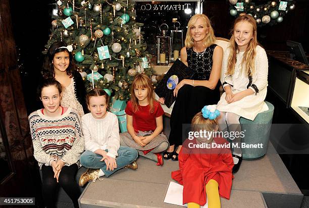 Joely Richardson poses with children as she officially opens the Tiffany & Co. Christmas Shop on Bond Street, London on November 24, 2013 in London,...