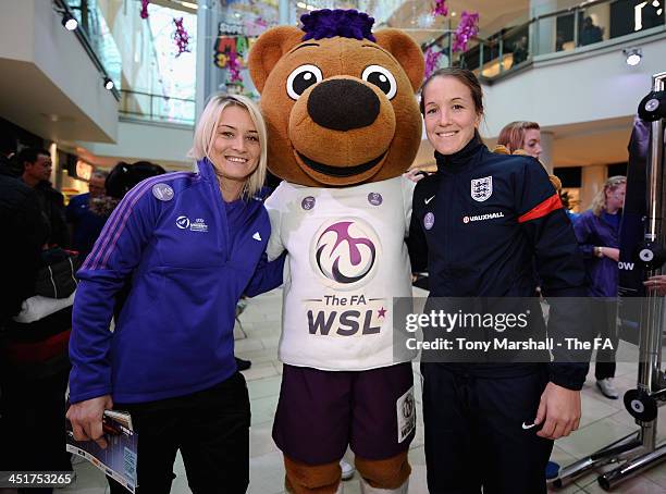 Berry The Bear poses with Megan Harris ( and Casey Stoney of Lincoln Ladies during the FA Girls' Football Fanzone at Highcross Shopping Centre on...