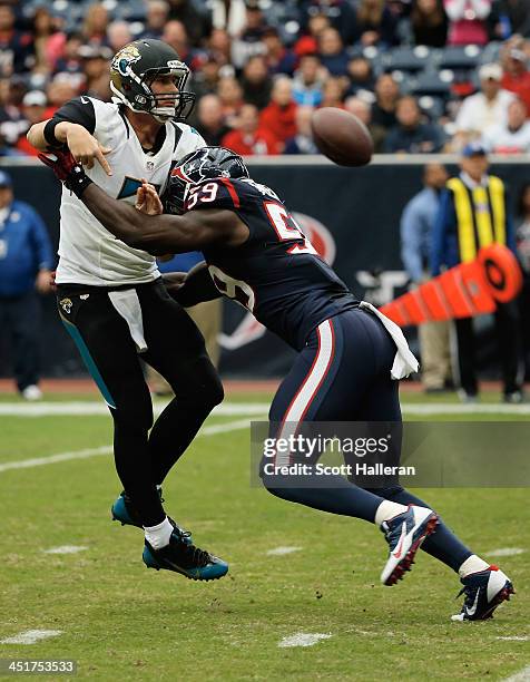 Chad Henne of the Jacksonville Jaguars is pressured in the first half by Whitney Mercilus of the Houston Texans at Reliant Stadium on November 24,...