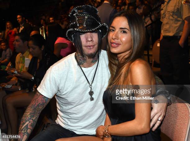 Guitarist Dj Ashba of Guns N Roses and his wife, model Nathalia Henao, attend the UFC 175 event at the Mandalay Bay Events Center on July 5, 2014 in...