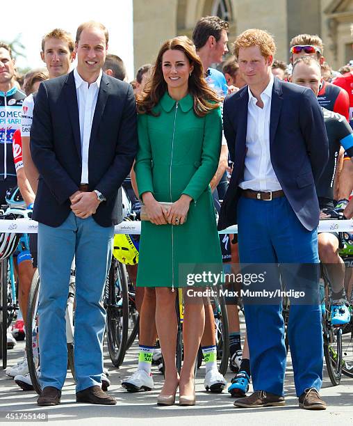 Prince William, Duke of Cambridge, Catherine, Duchess of Cambridge and Prince Harry pose for a photograph with Tour de France cyclists at the Tour de...