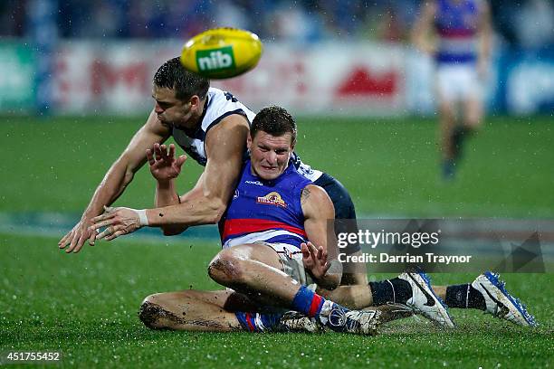 Jared Rivers of the Cats and Jack Redpath of the Bulldogs compete during the round 16 AFL match between the Geelong Cats and the Western Bulldogs at...