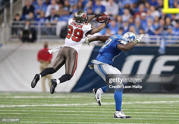 Leonard Johnson of the Tampa Bay Buccaneers intercepts a pass in front of Brandon Pettigrew of the Detroit Lions and runs it back 48 yards for a...