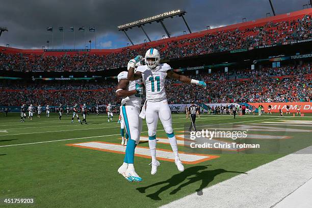 Mike Wallace of the Miami Dolphins celebrates his first quarter touchdown with teammate Dion Sims of the Miami Dolphins against the Carolina Panthers...