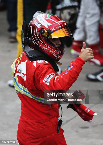 Felipe Massa of Brazil and Ferrari celebrates as he finishes his last race for Ferrari following the Brazilian Formula One Grand Prix at Autodromo...